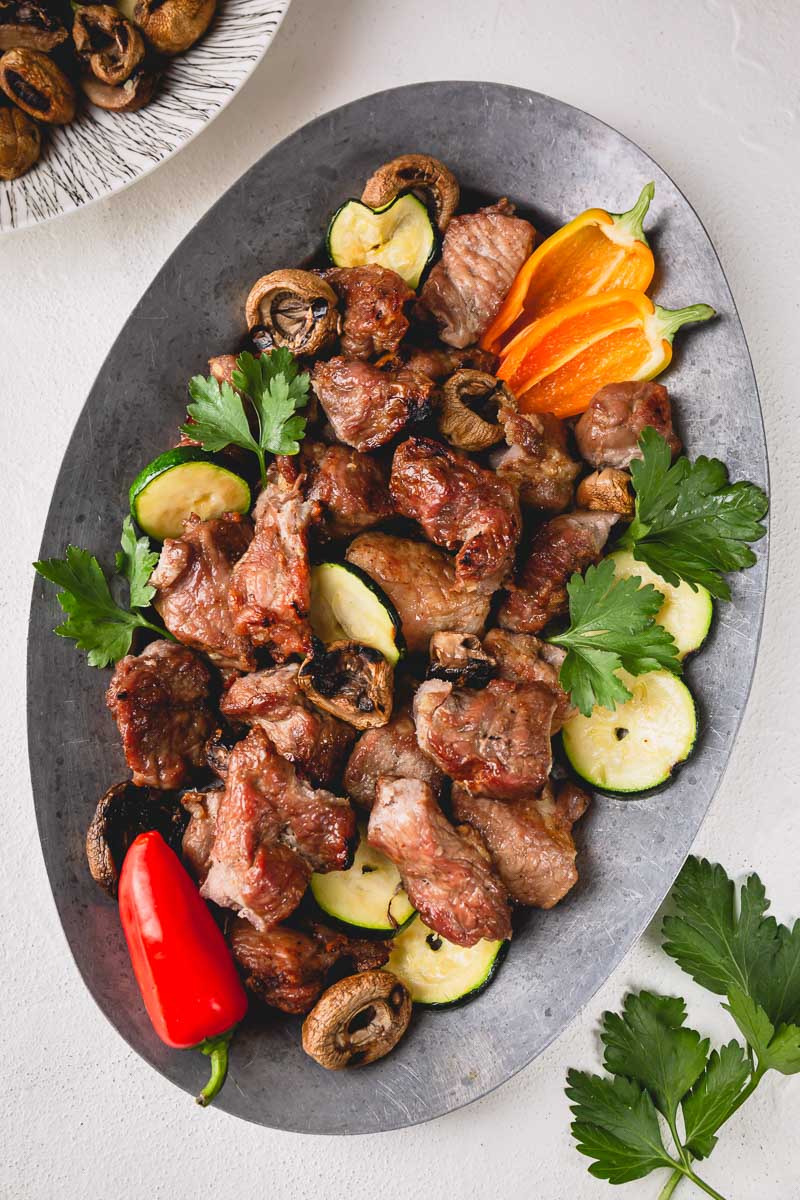 Marinated barbecue meat on skewer. Shish kebab or Shashlyk meaning skewered  meat. Beef or pork on grill on an open fire. Street food, picnic concept  Stock Photo